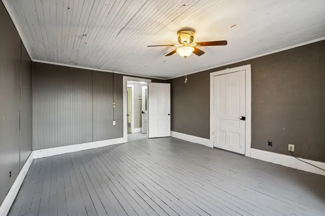 a view of a room with wooden floor and furniture