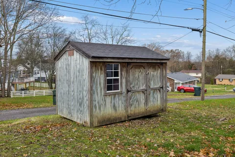 a view of a house with a yard and furniture