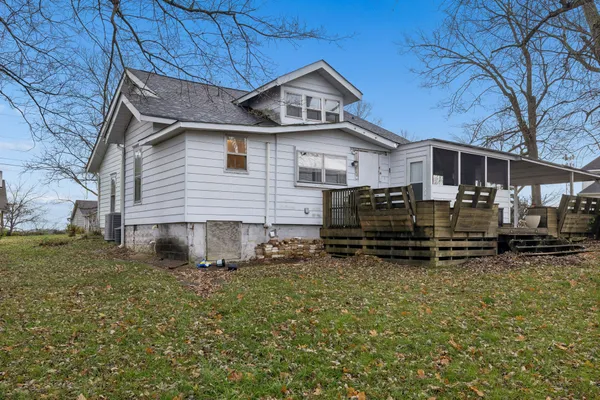 a backyard of a house with barbeque oven table and chairs