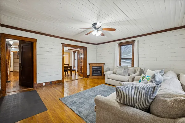 a living room with furniture and a wooden floor