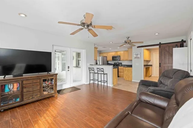 a kitchen with stainless steel appliances granite countertop a refrigerator a stove top oven and sink