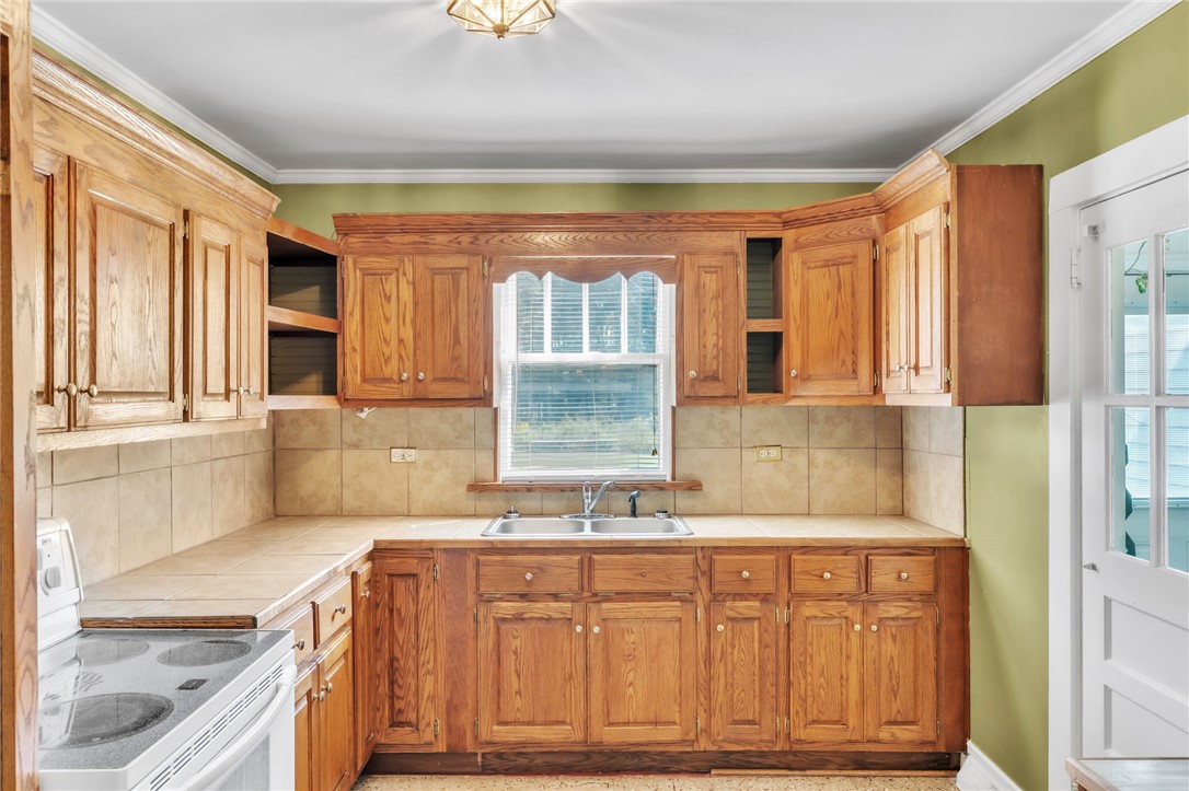 121 Ellison Street Belton, SC 29627 - Photo 6 of 30 This bright kitchen features ample cabinetry and a window above the sink.