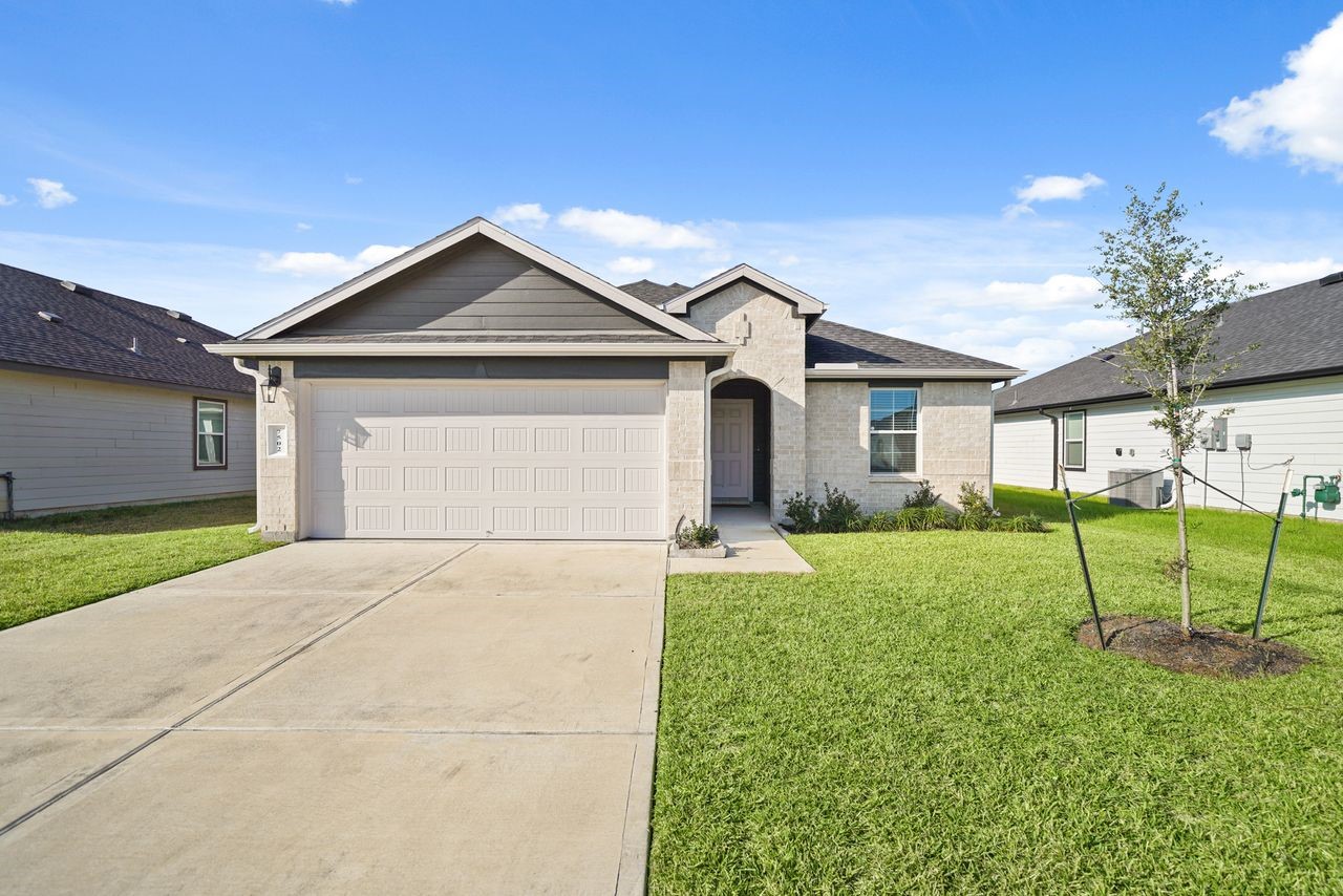 a front view of a house with a yard and garage