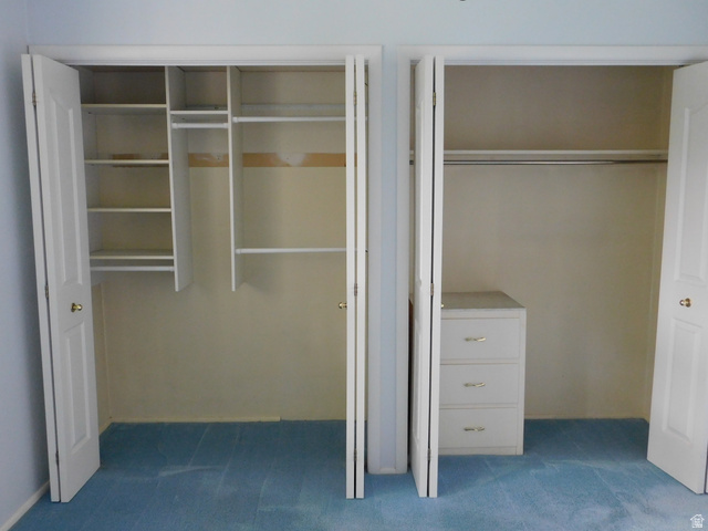 2148 Carolyn Way Bountiful, UT 84010 - Photo 13 of 40 Dual closet spaces featuring bi-fold doors, white shelving, and hanging rods
