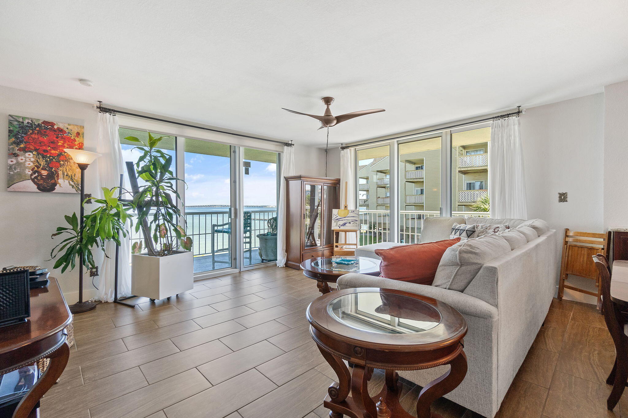 1200 Fort Pickens Road, Unit 1E Pensacola Beach, FL 32561 - Photo 11 of 44 a living room with furniture a flat screen tv and a large window