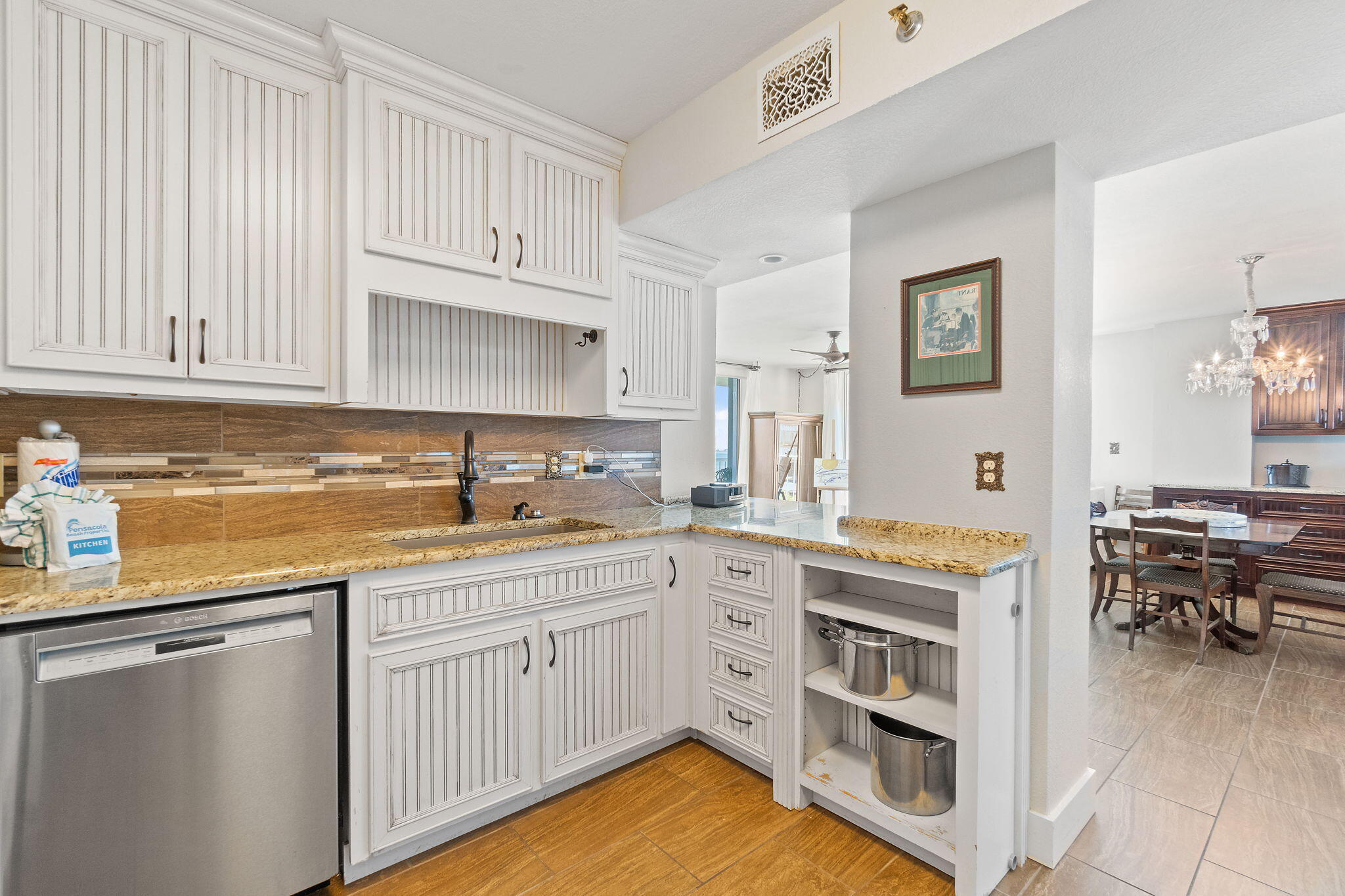 1200 Fort Pickens Road, Unit 1E Pensacola Beach, FL 32561 - Photo 20 of 44 a kitchen with white cabinets and sink