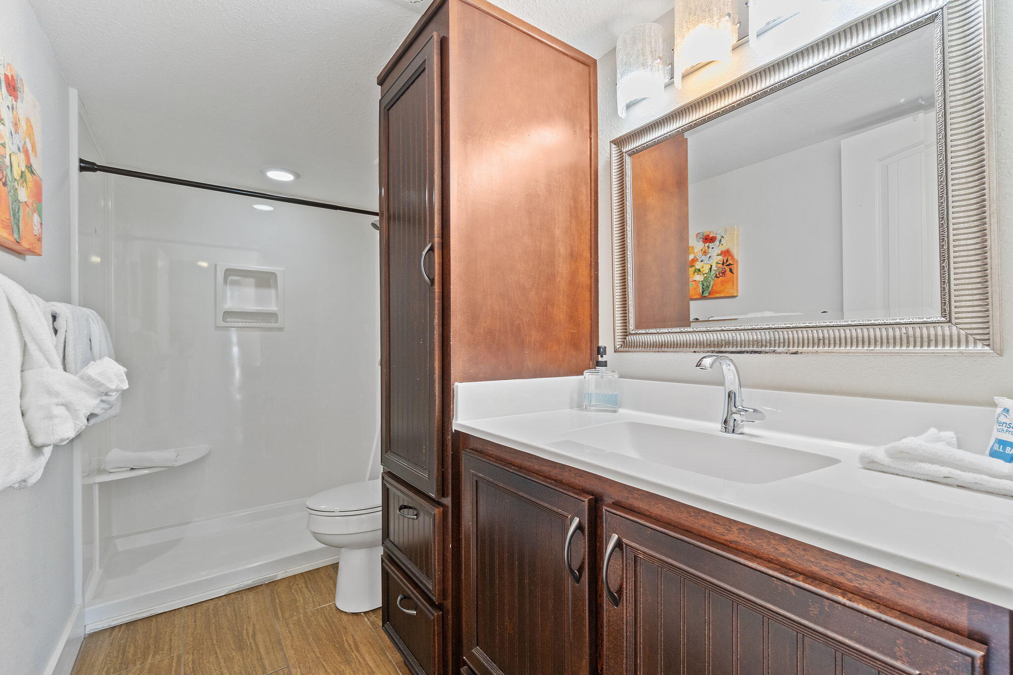 1200 Fort Pickens Road, Unit 1E Pensacola Beach, FL 32561 - Photo 22 of 44 a bathroom with a sink and mirror with toilet