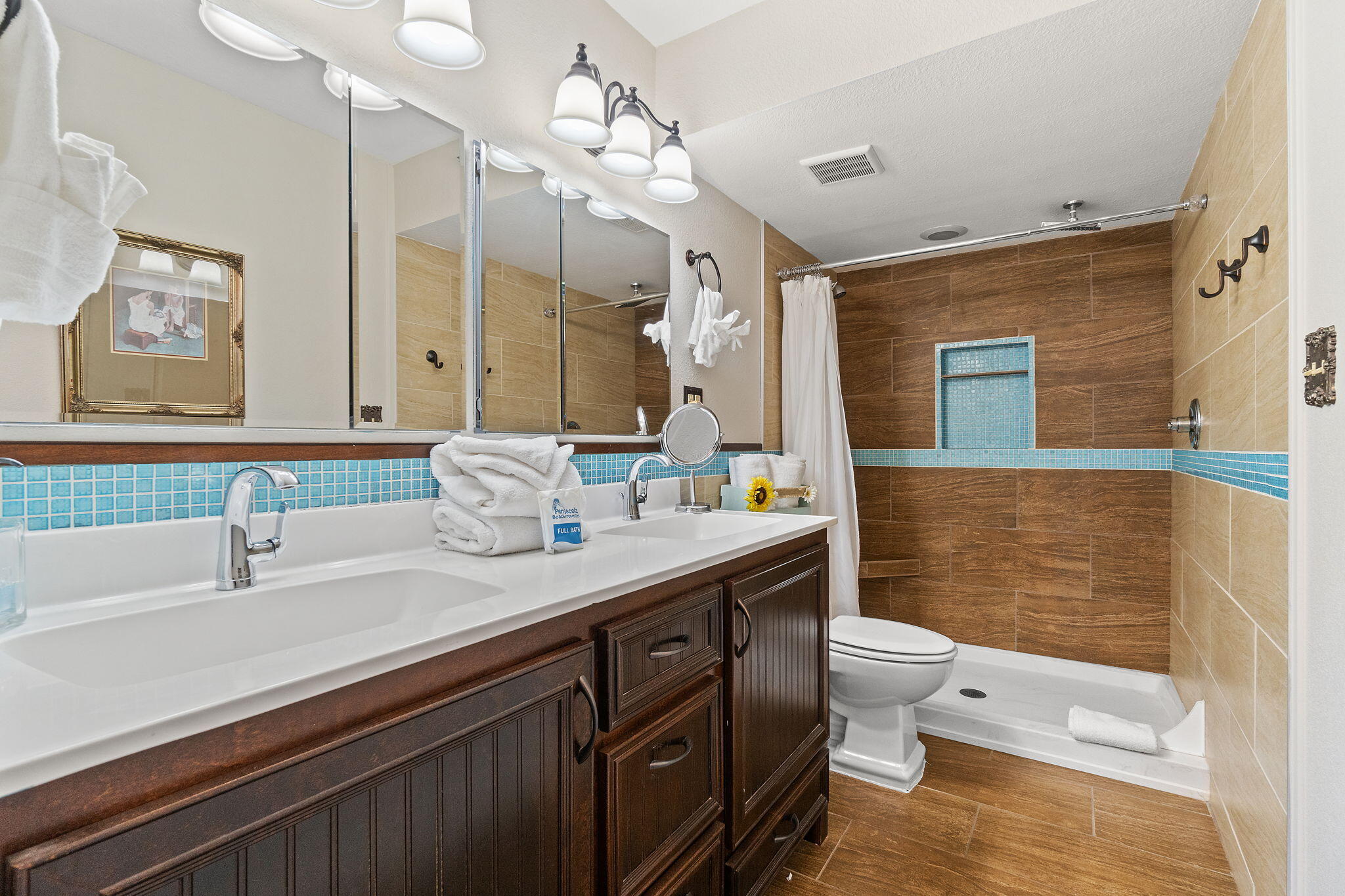1200 Fort Pickens Road, Unit 1E Pensacola Beach, FL 32561 - Photo 28 of 44 a bathroom with a granite countertop sink a toilet a mirror and shower