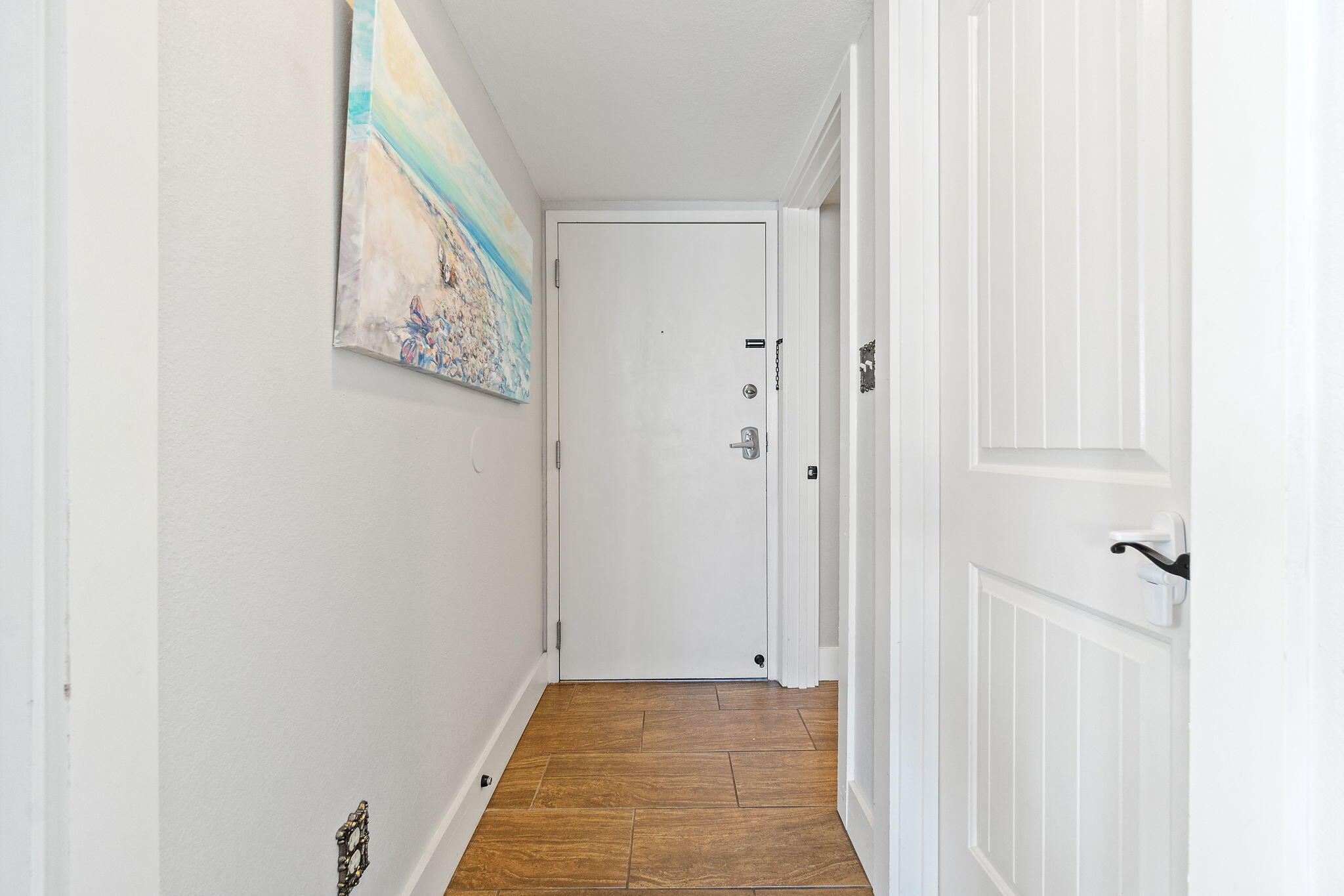 1200 Fort Pickens Road, Unit 1E Pensacola Beach, FL 32561 - Photo 10 of 44 a view of a hallway with wooden floor and closet