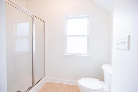 a bathroom with a granite countertop sink mirror and a bathtub