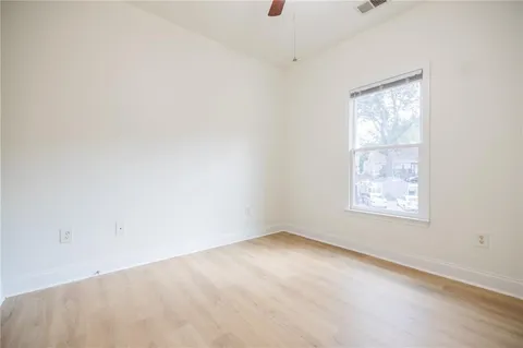 an empty room with closet and entryway