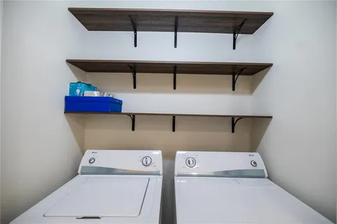 a view of a hallway with a livingroom and entryway