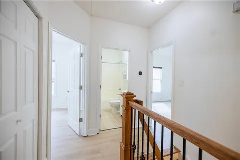 a view of a balcony with door and wooden floor