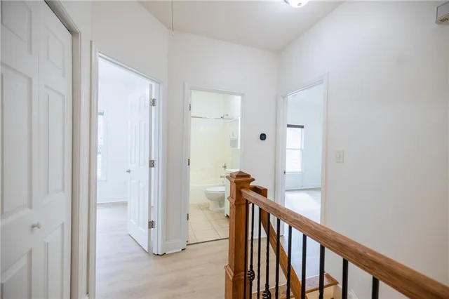 a view of a balcony with door and wooden floor