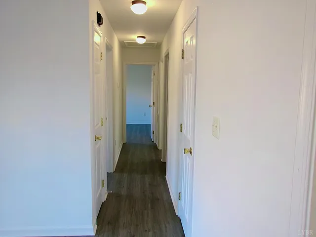 a view of a hallway with a wooden floor