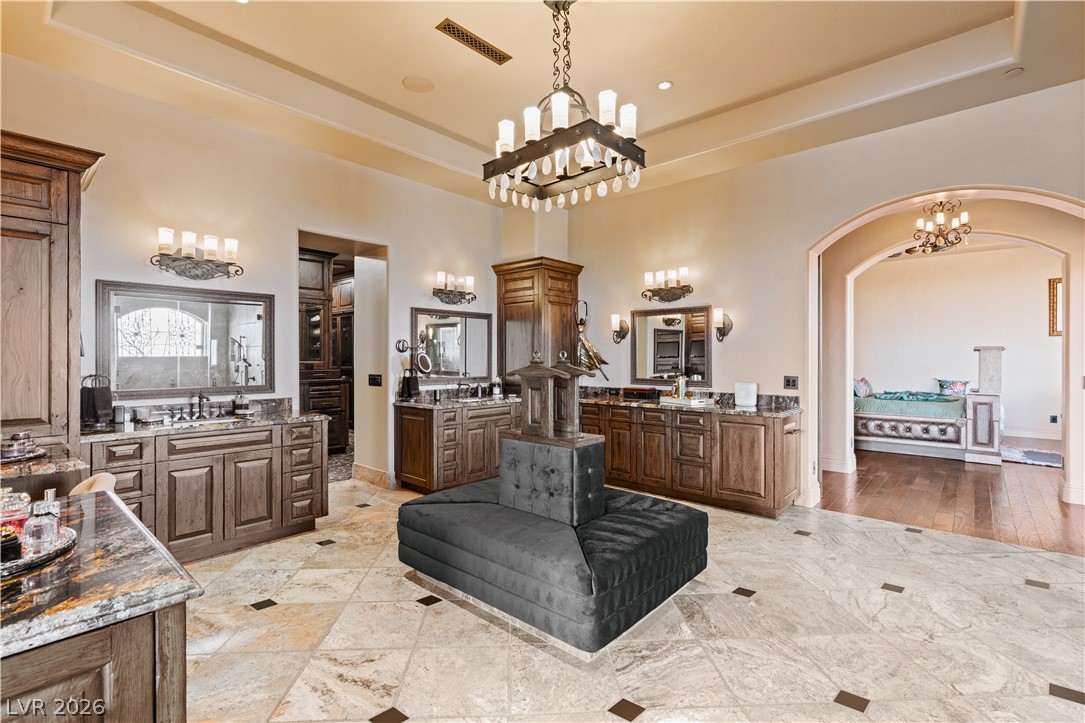 1123 Christian Road Henderson, NV 89002 - Photo 26 of 94 Luxurious primary bath with double vanities, rich cabinetry, and exquisite tile flooring.