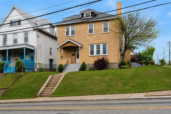 a front view of a house with a yard
