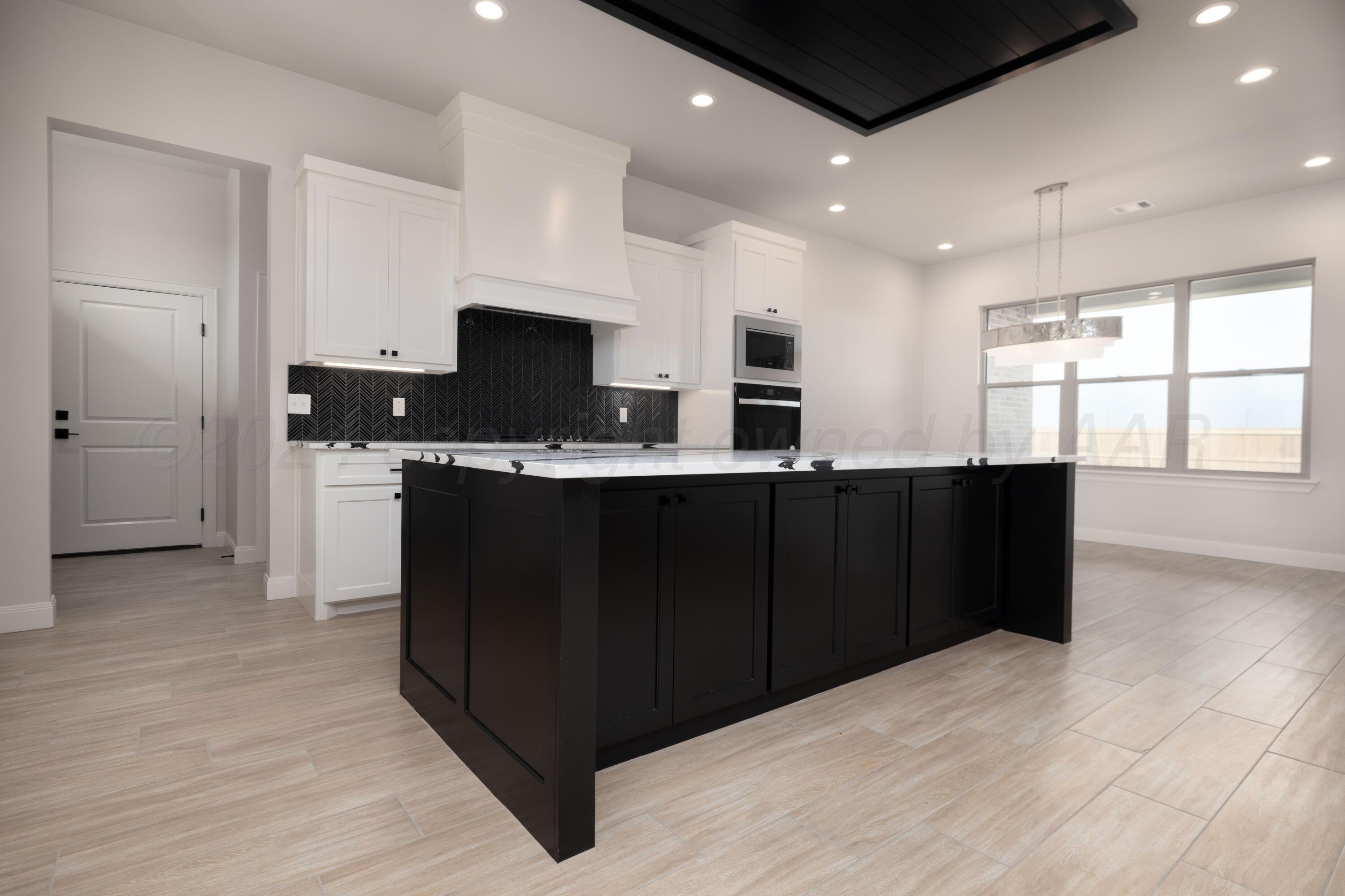 10150 Cactus Flower Road Amarillo, TX 79119 - Photo 11 of 47 a kitchen with a sink and cabinets