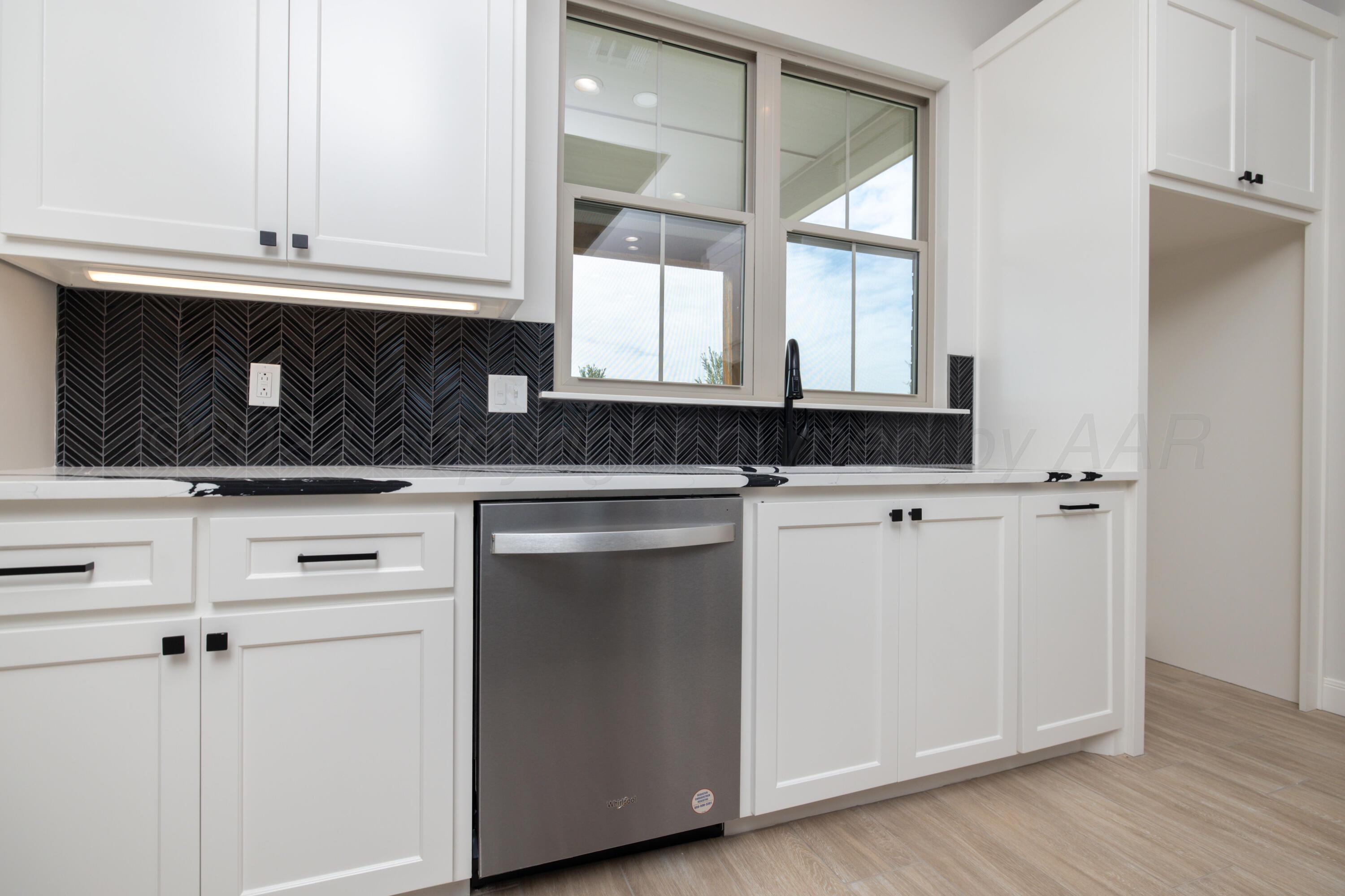 10150 Cactus Flower Road Amarillo, TX 79119 - Photo 12 of 47 a kitchen with granite countertop white cabinets and white appliances