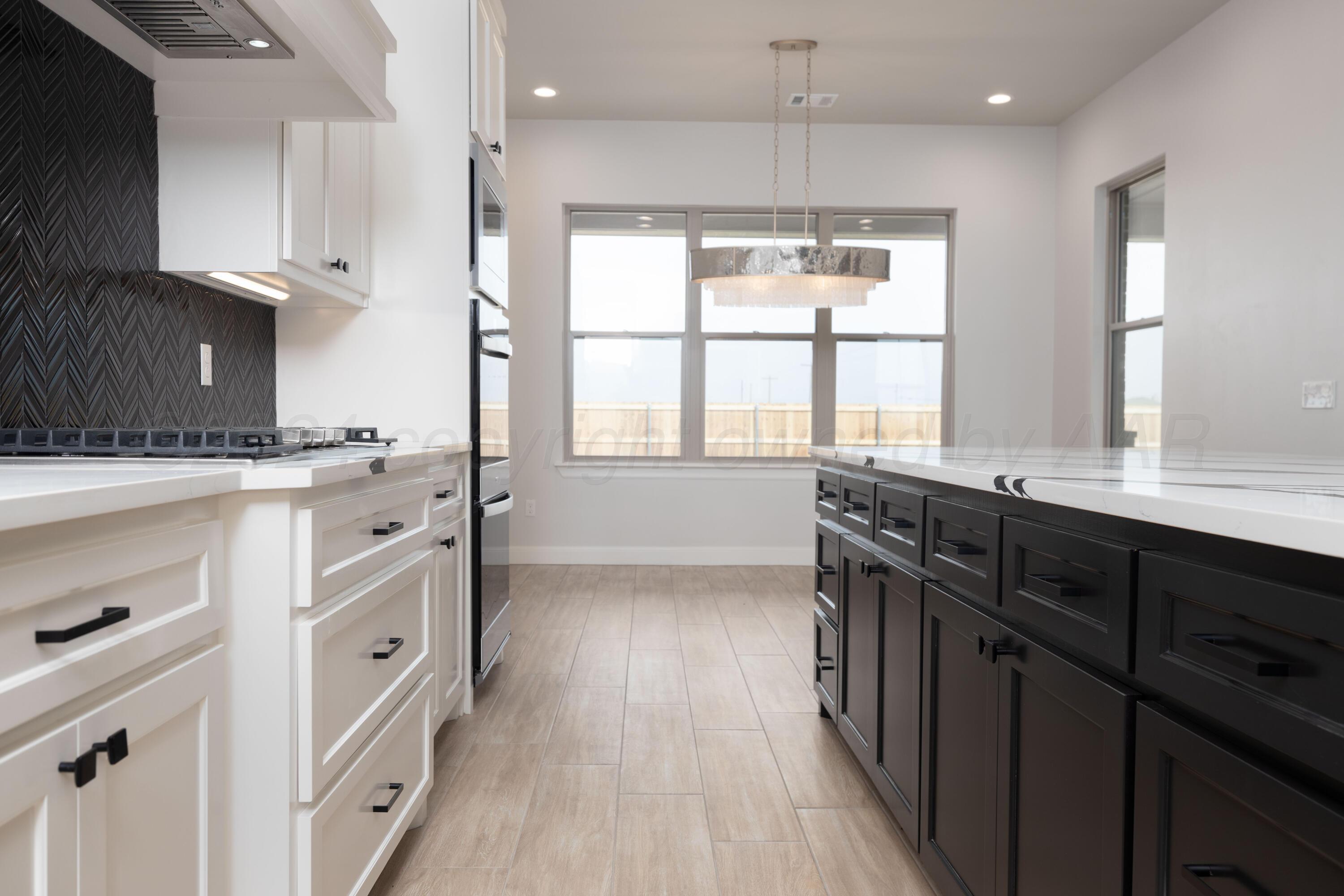 10150 Cactus Flower Road Amarillo, TX 79119 - Photo 14 of 47 a kitchen with stainless steel appliances sink stove and cabinets
