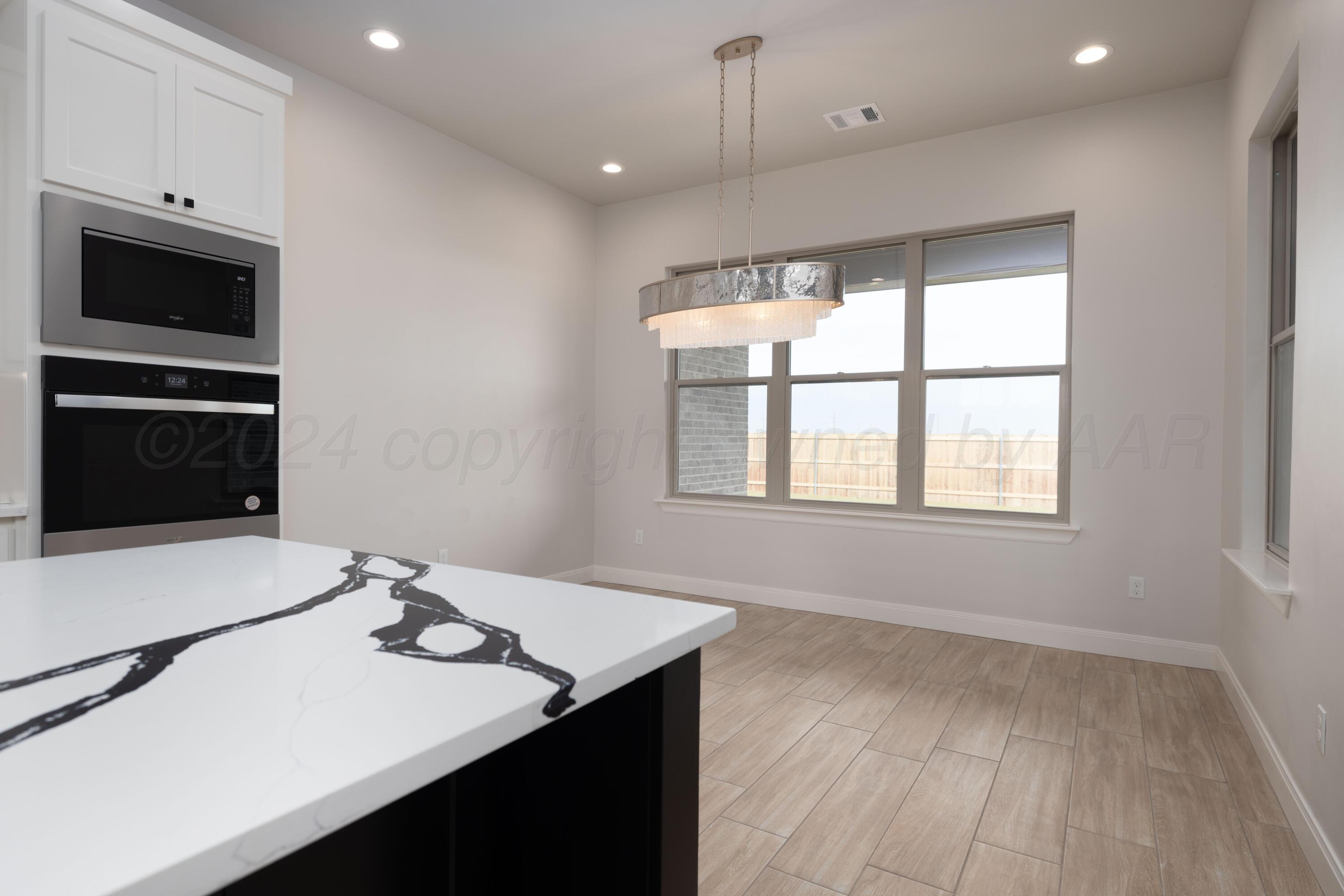 10150 Cactus Flower Road Amarillo, TX 79119 - Photo 18 of 47 a kitchen with a sink a stove and microwave