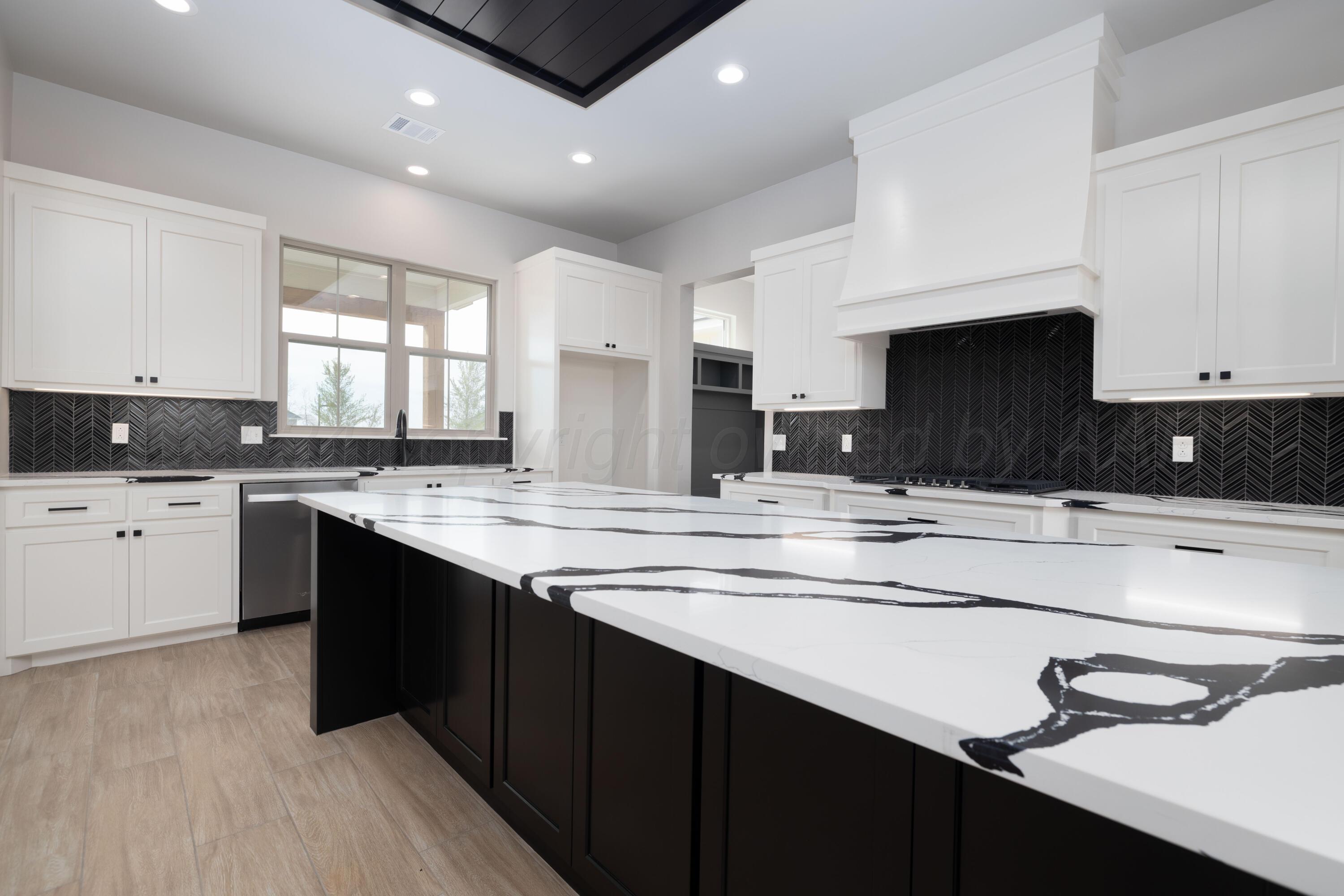 10150 Cactus Flower Road Amarillo, TX 79119 - Photo 19 of 47 a kitchen with a sink window and cabinets