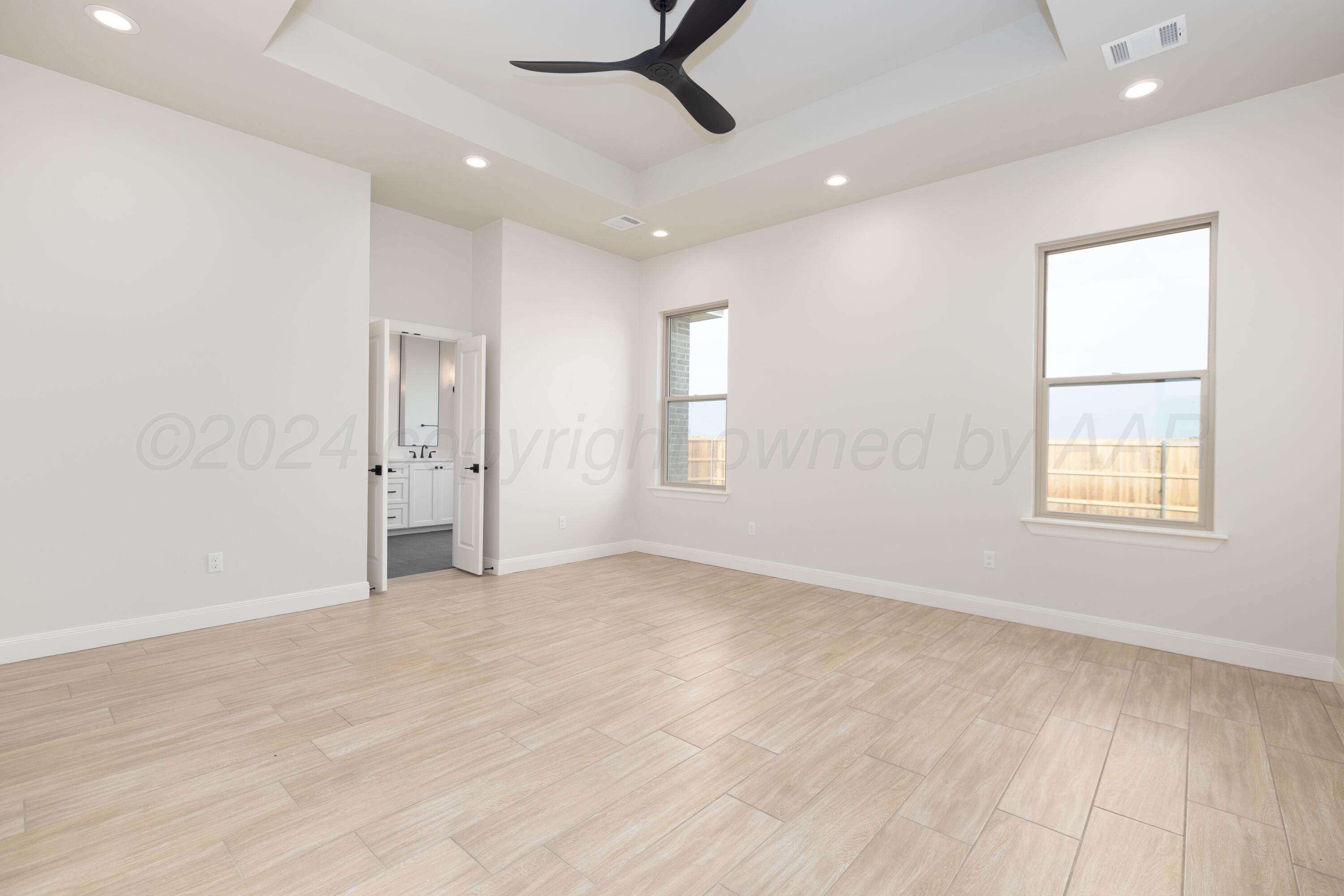 10150 Cactus Flower Road Amarillo, TX 79119 - Photo 23 of 47 an empty room with windows and cabinet