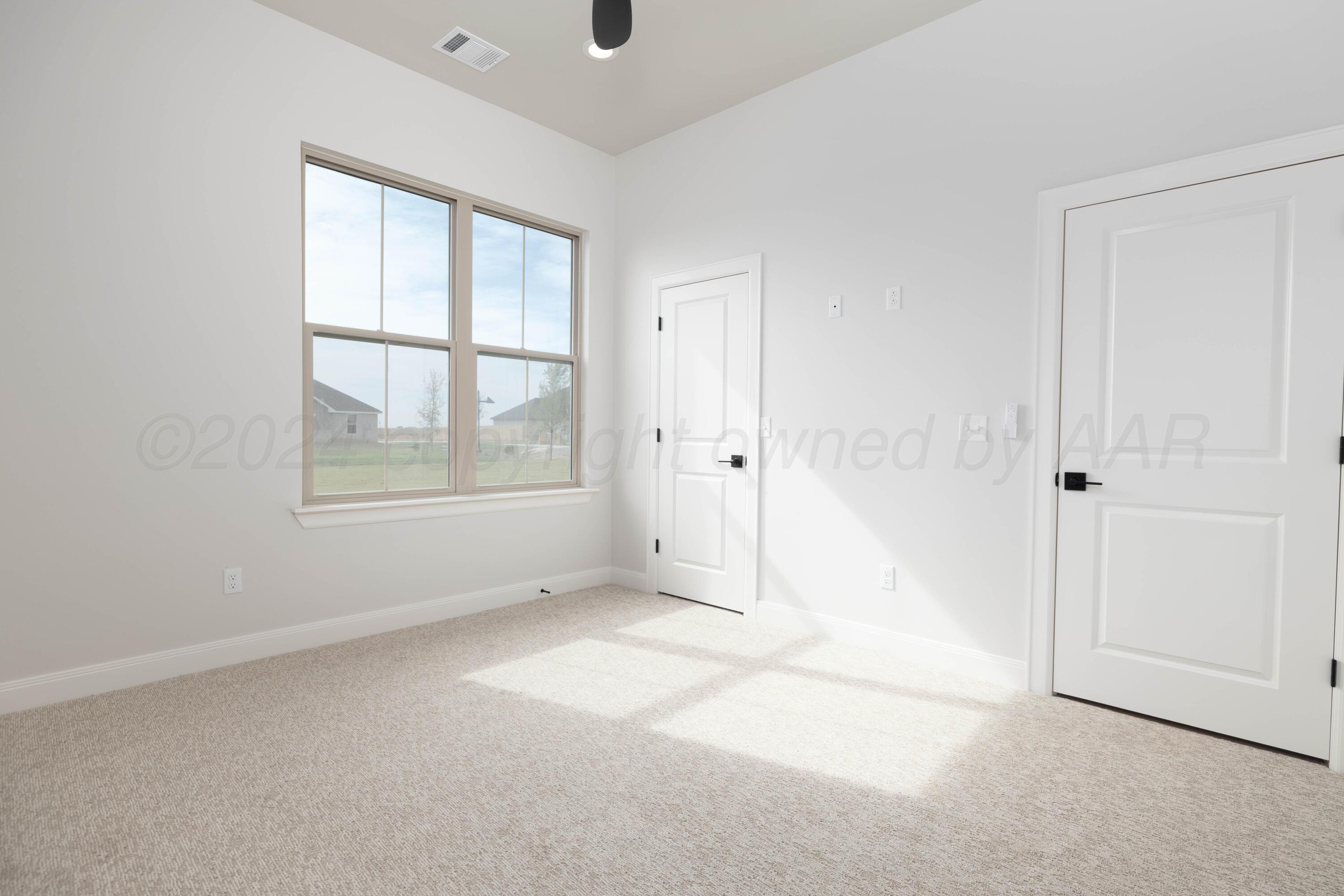 10150 Cactus Flower Road Amarillo, TX 79119 - Photo 36 of 47 an empty room with windows and closet