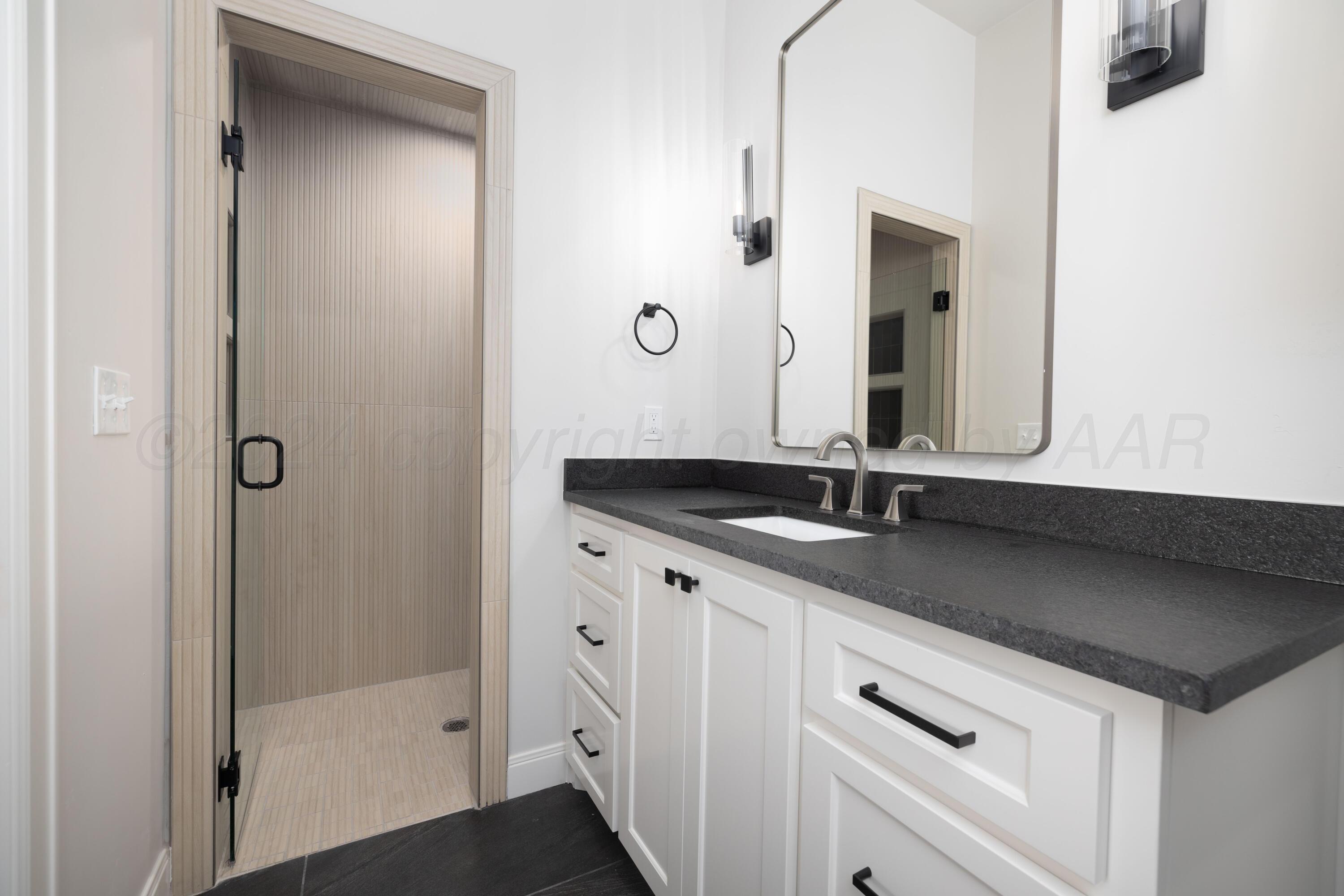 10150 Cactus Flower Road Amarillo, TX 79119 - Photo 39 of 47 a bathroom with a sink and a mirror