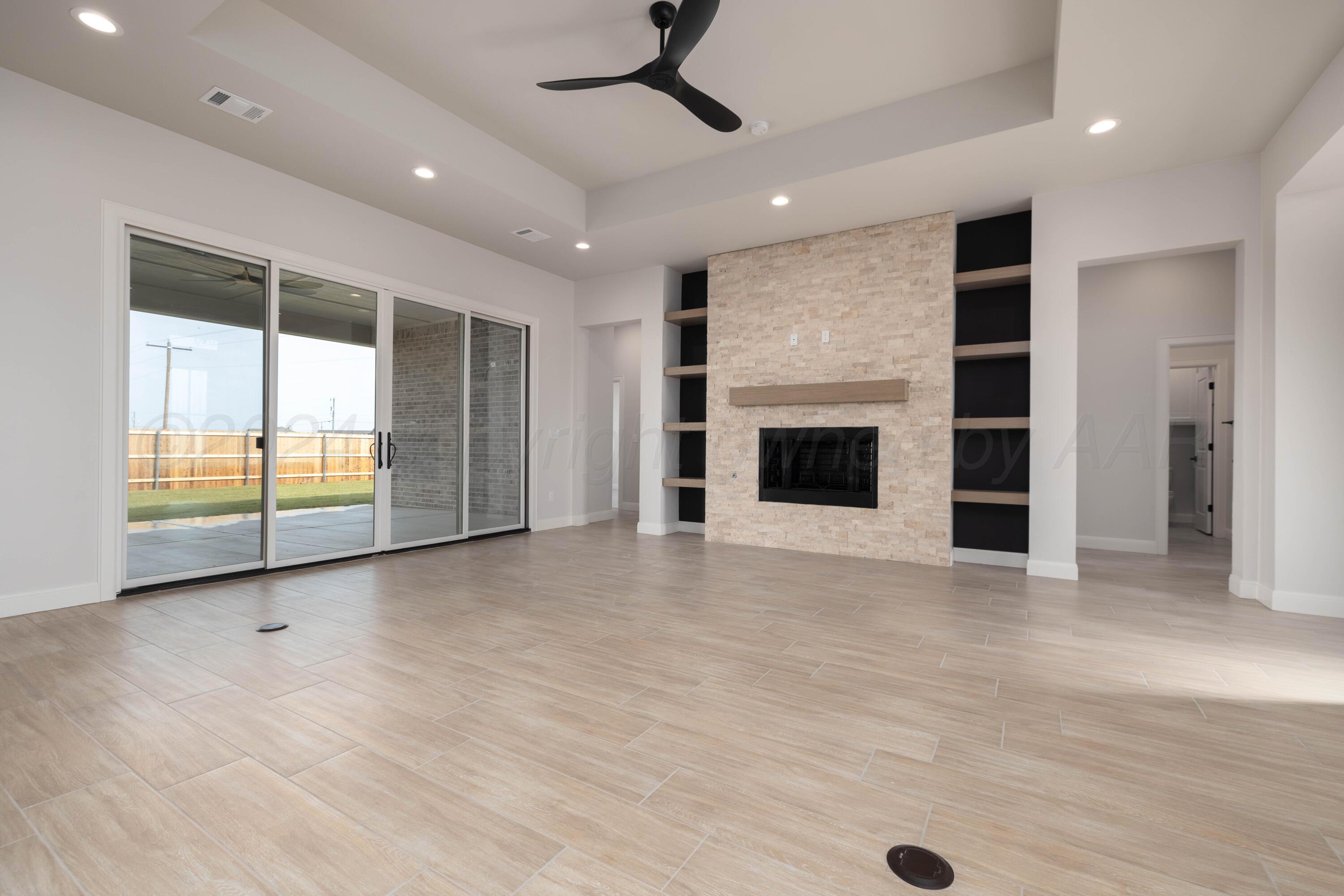 10150 Cactus Flower Road Amarillo, TX 79119 - Photo 4 of 47 an empty room with fireplace and windows