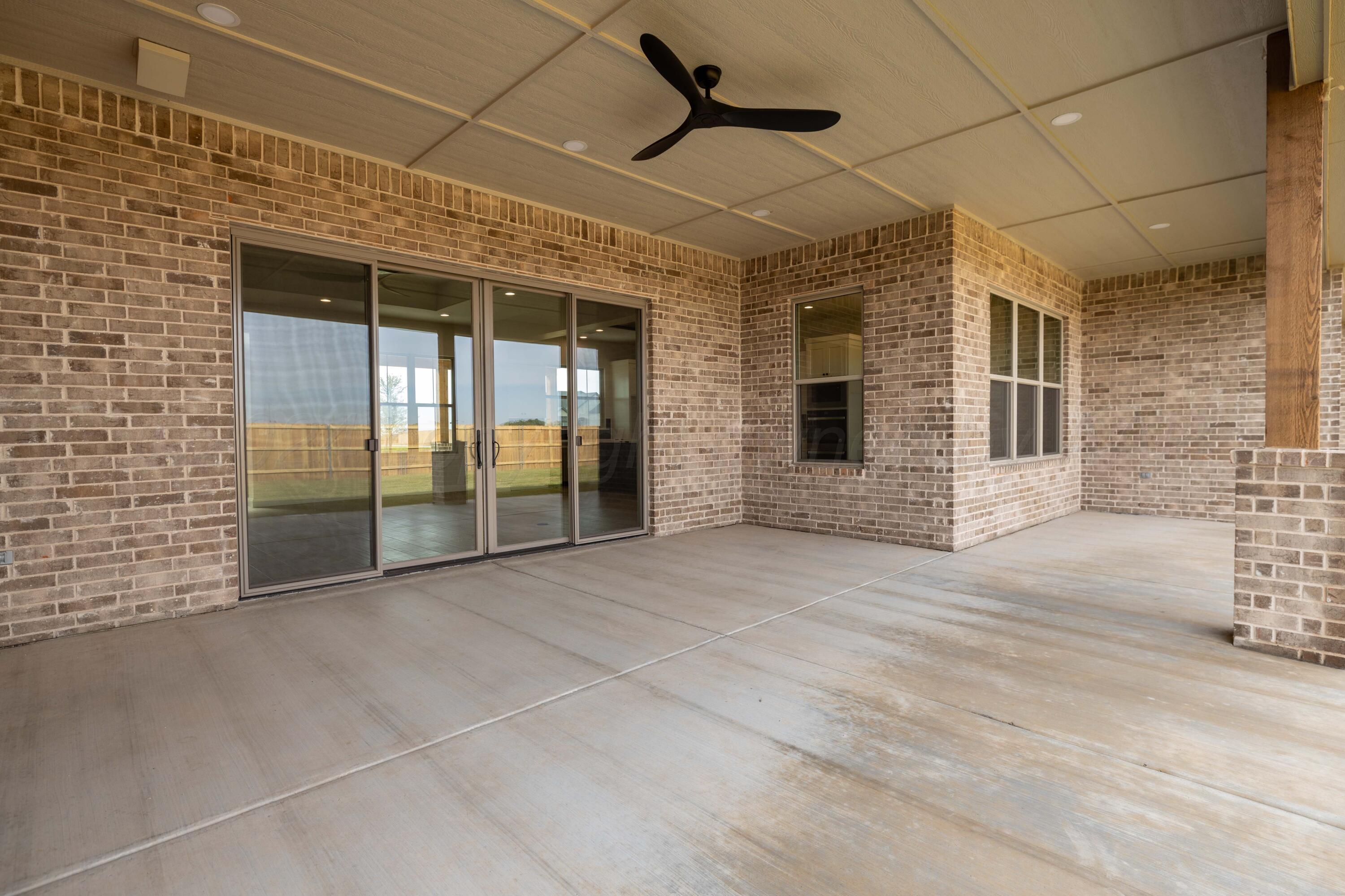 10150 Cactus Flower Road Amarillo, TX 79119 - Photo 45 of 47 a view of a brick house with a large window
