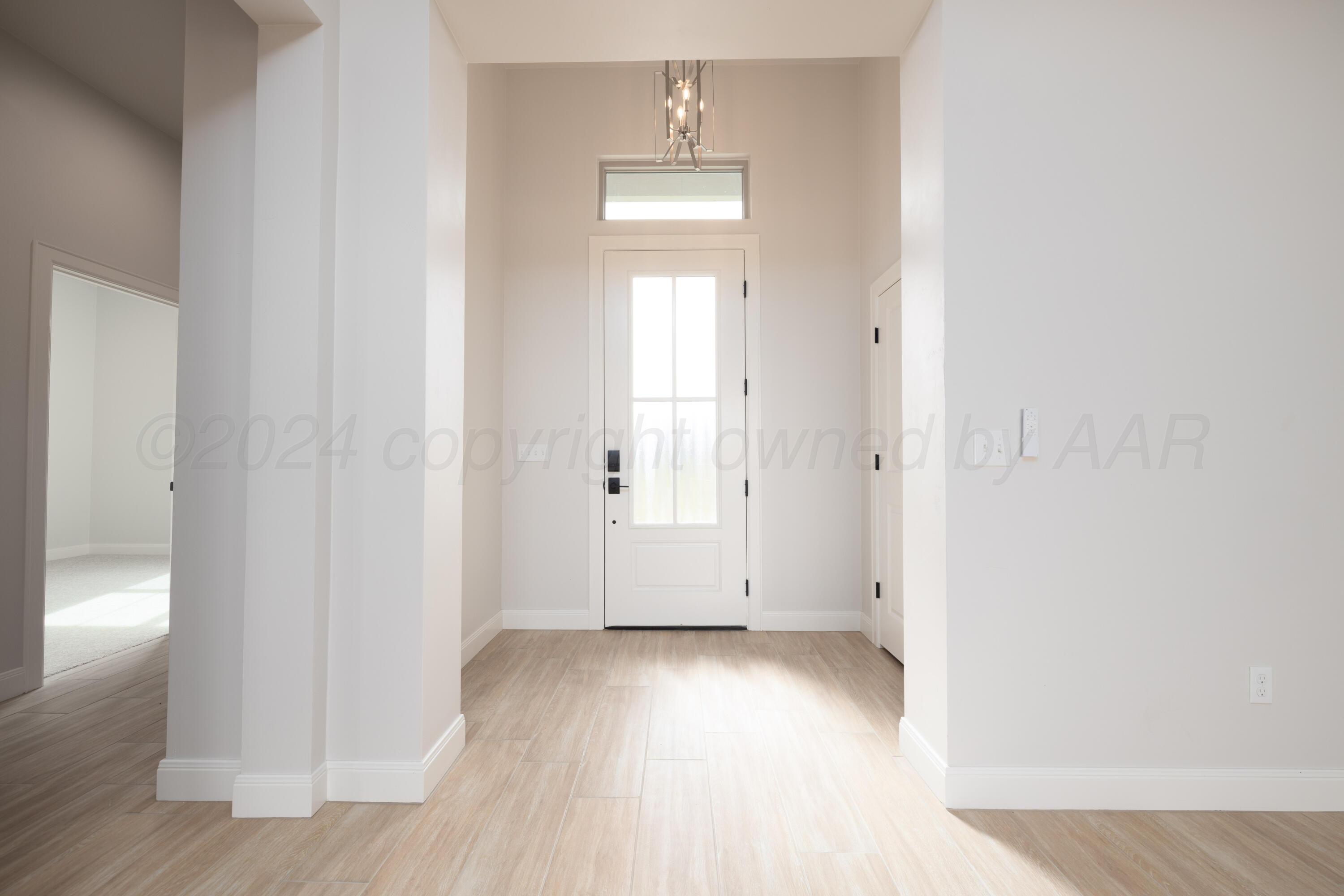 10150 Cactus Flower Road Amarillo, TX 79119 - Photo 7 of 47 an empty room with wooden floor and windows