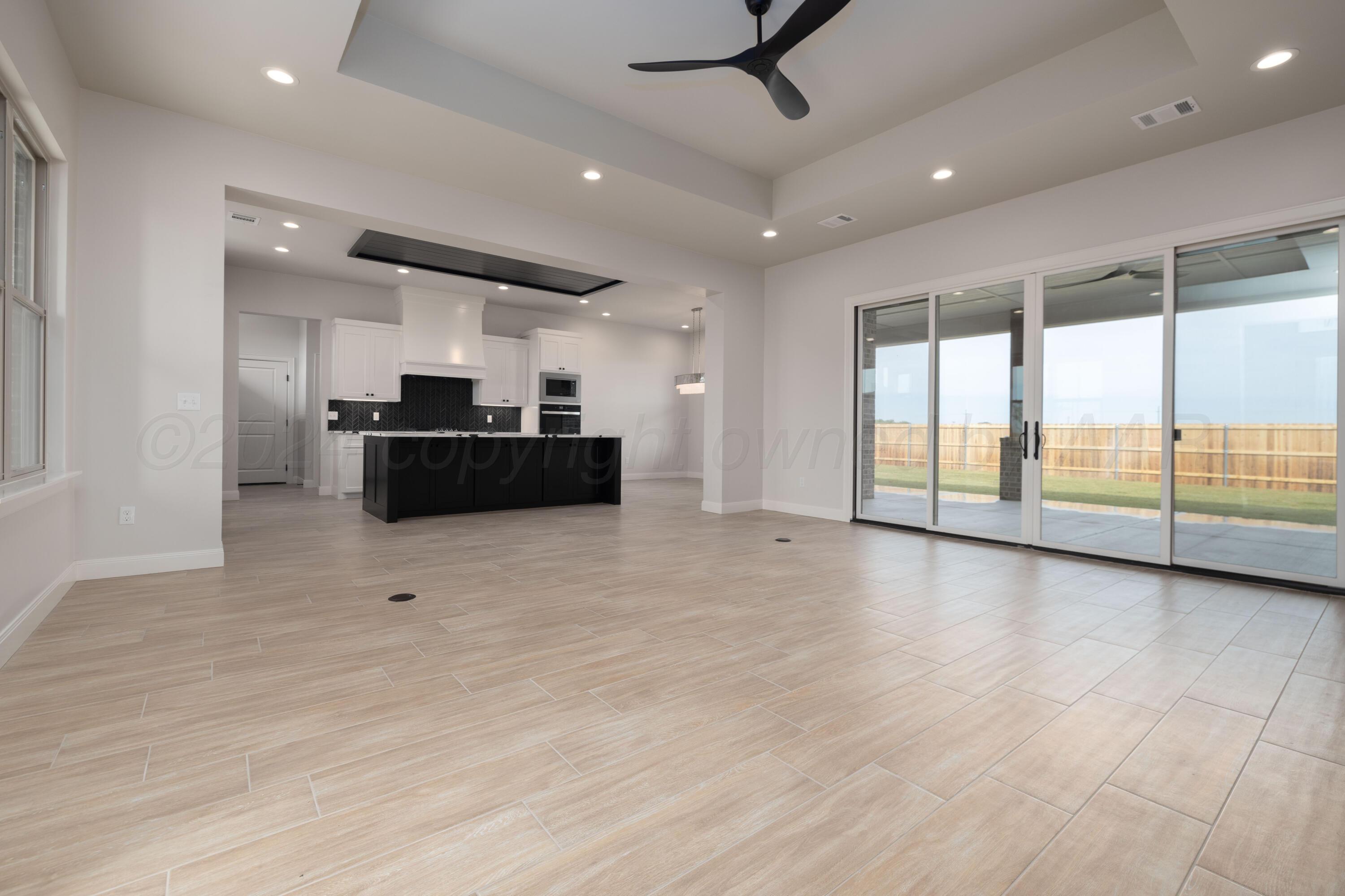 10150 Cactus Flower Road Amarillo, TX 79119 - Photo 8 of 47 a view of a kitchen with kitchen island stainless steel appliances wooden floor and window