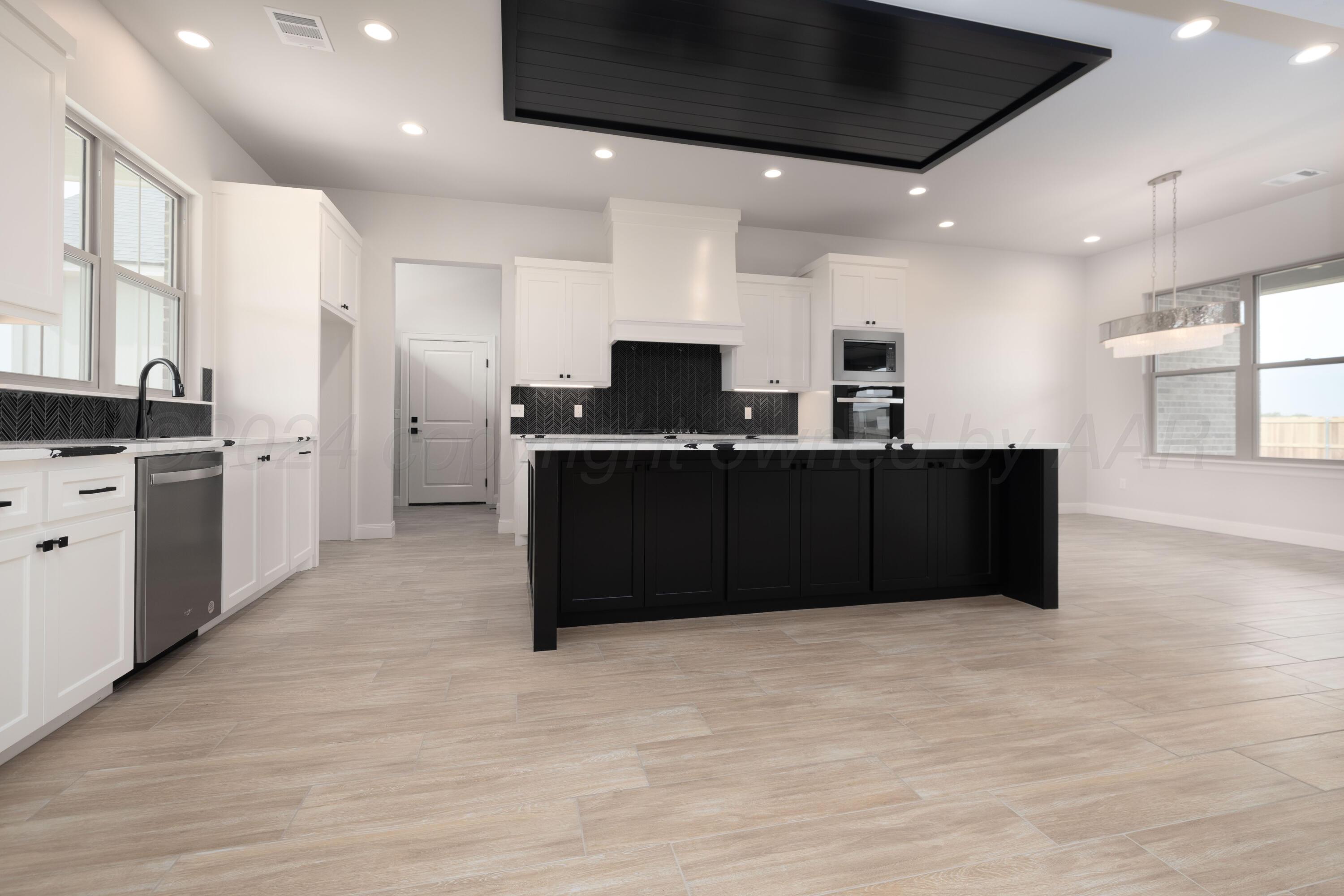 10150 Cactus Flower Road Amarillo, TX 79119 - Photo 10 of 47 a kitchen with stainless steel appliances kitchen island granite countertop a refrigerator and a stove top oven