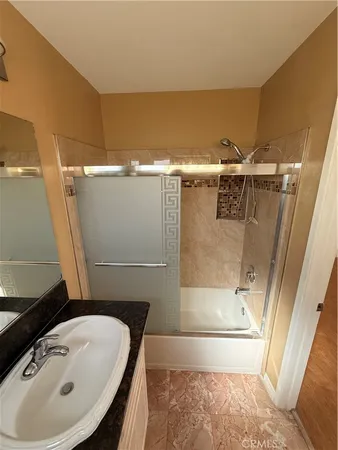 a bathroom with a granite countertop toilet sink and mirror