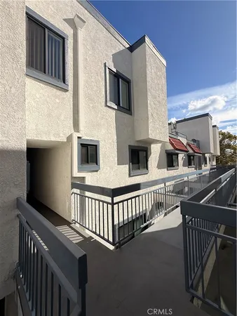 a view of balcony with two chairs and a window