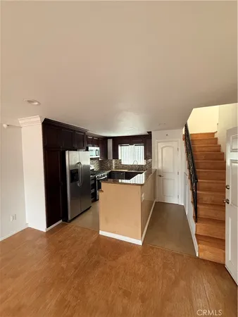 a view of kitchen and wooden floor
