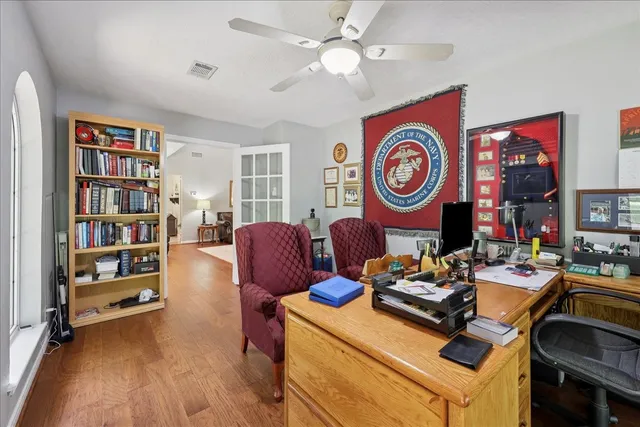 a view of a workspace with furniture and a bookshelf