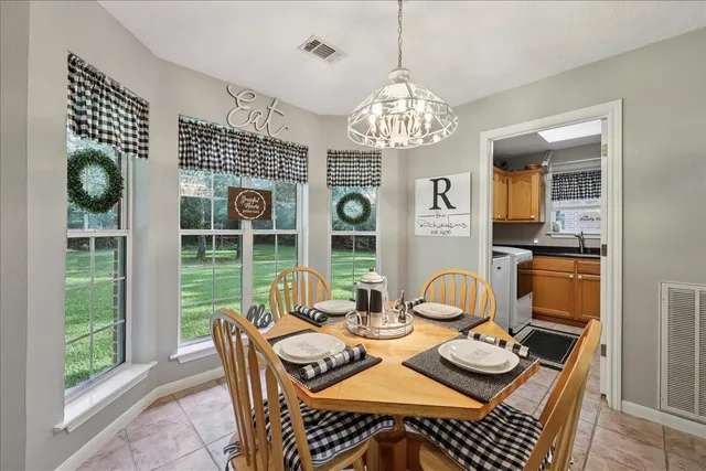 a view of a dining room with furniture wooden floor and chandelier