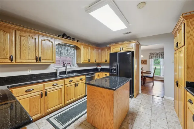 a kitchen with stainless steel appliances granite countertop a sink and cabinets