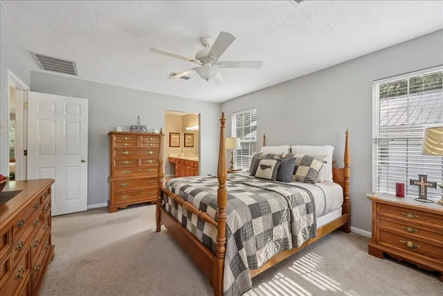 a bedroom with a bed and ceiling fan