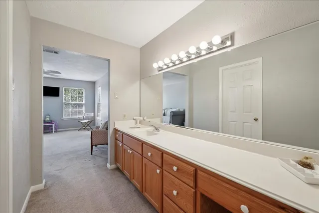 a spacious bathroom with a double vanity sink and a mirror