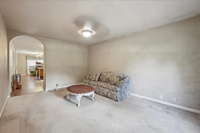 a living room with furniture and a white walls