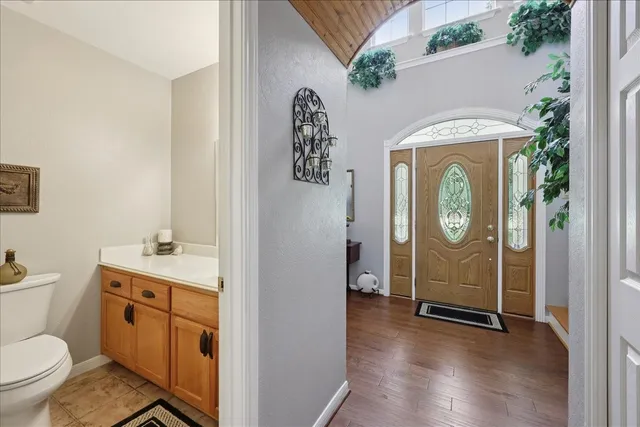 a view of bathroom with a toilet sink and mirror