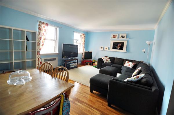 1498 Beacon Street, Unit 4 Brookline, MA 02446 - Photo 2 of 8 a living room with furniture and a flat screen tv