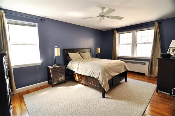 1498 Beacon Street, Unit 4 Brookline, MA 02446 - Photo 4 of 8 a bedroom with a large bed and a chandelier