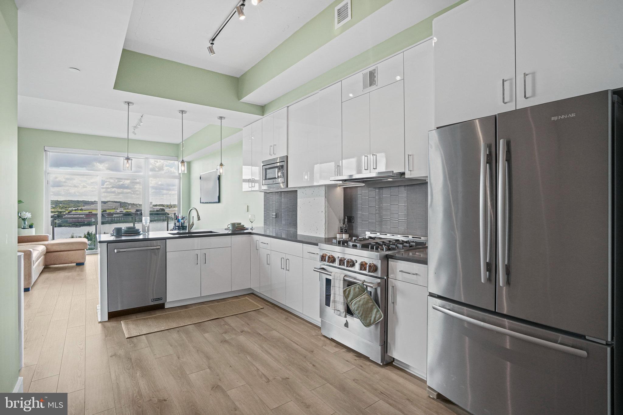 88 V Street Southwest, Unit 807 Washington, DC 20024 - Photo 12 of 57 a kitchen with stainless steel appliances a refrigerator a stove and white cabinets