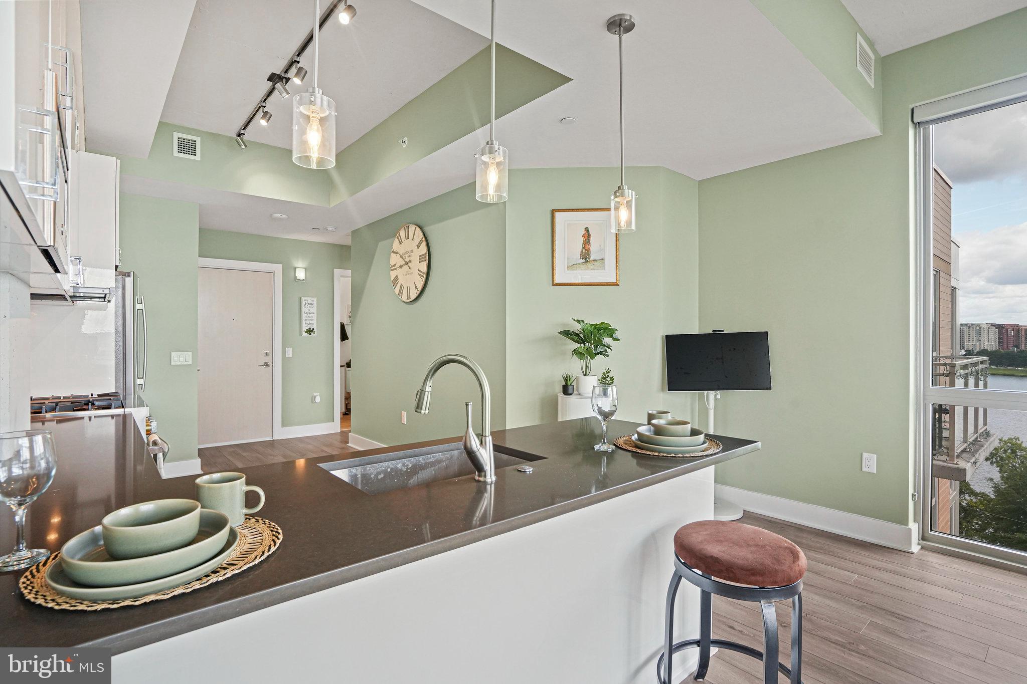 88 V Street Southwest, Unit 807 Washington, DC 20024 - Photo 17 of 57 a kitchen with a table and chairs in it