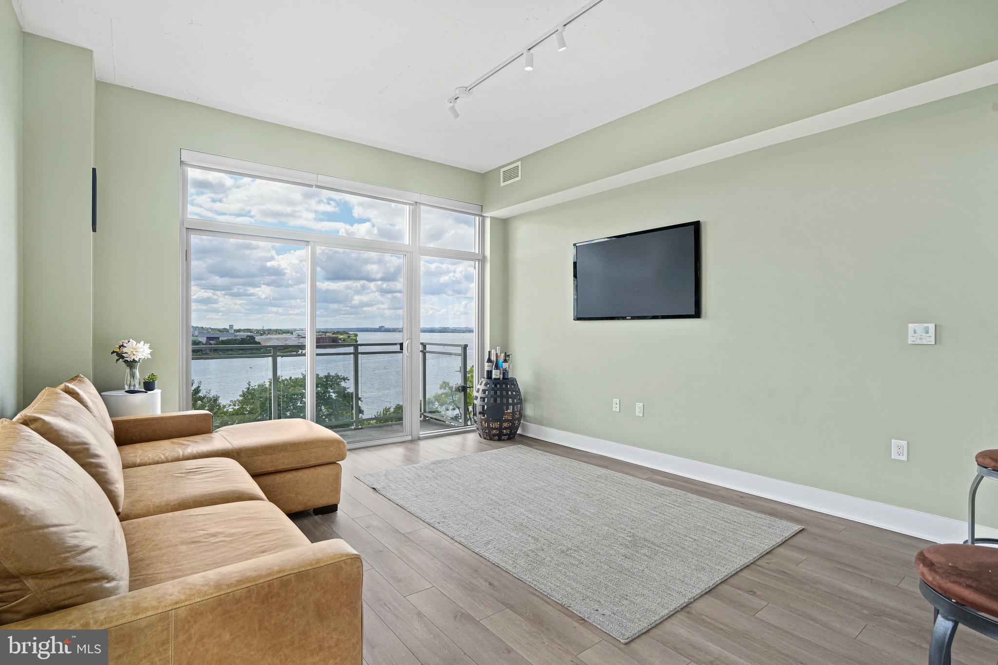 88 V Street Southwest, Unit 807 Washington, DC 20024 - Photo 19 of 57 a living room with furniture and a floor to ceiling window