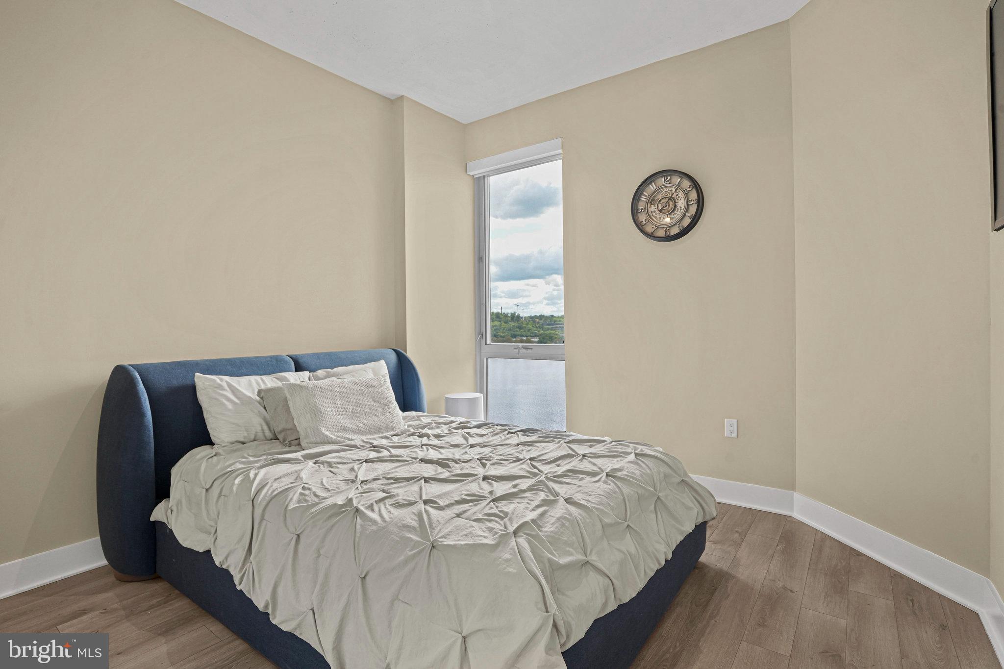 88 V Street Southwest, Unit 807 Washington, DC 20024 - Photo 26 of 57 a large bed sitting in a bedroom next to a window